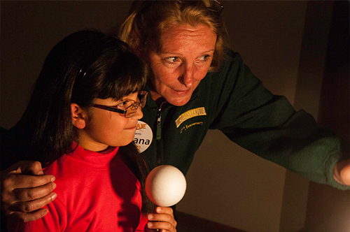 Viviana Bianchi, a Gemini South volunteer from Argentina, capturing the attention of a young student from St. Mary's school in La Serena by sharing an activity on the phases of the Moon.