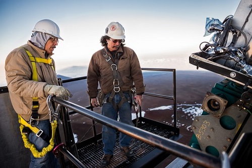 Picture of Steve Hardash (left) and Cooper Nakayama (right) inspecting the drive box after reinstallation on the Gemini North dome.
