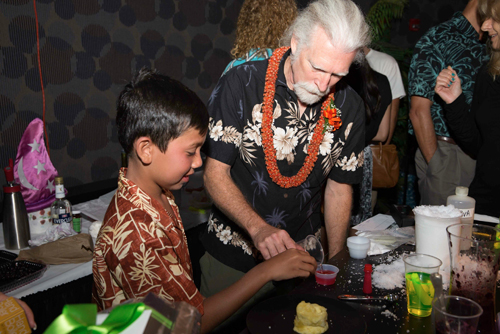 Photo of Steve showing a very engaged nine year old how to create slime.