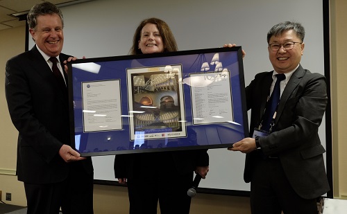 Photo of AURA President Matt Mountain and NSF Mathematics and Physical Sciences Directorate Chief Anne Kinney presenting a commemorative plaque to KASI President Hyung Mok Lee during the KASI signing ceremony in San Francisco.