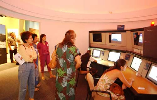 Photo of a group of people using the former Gemini North control console.